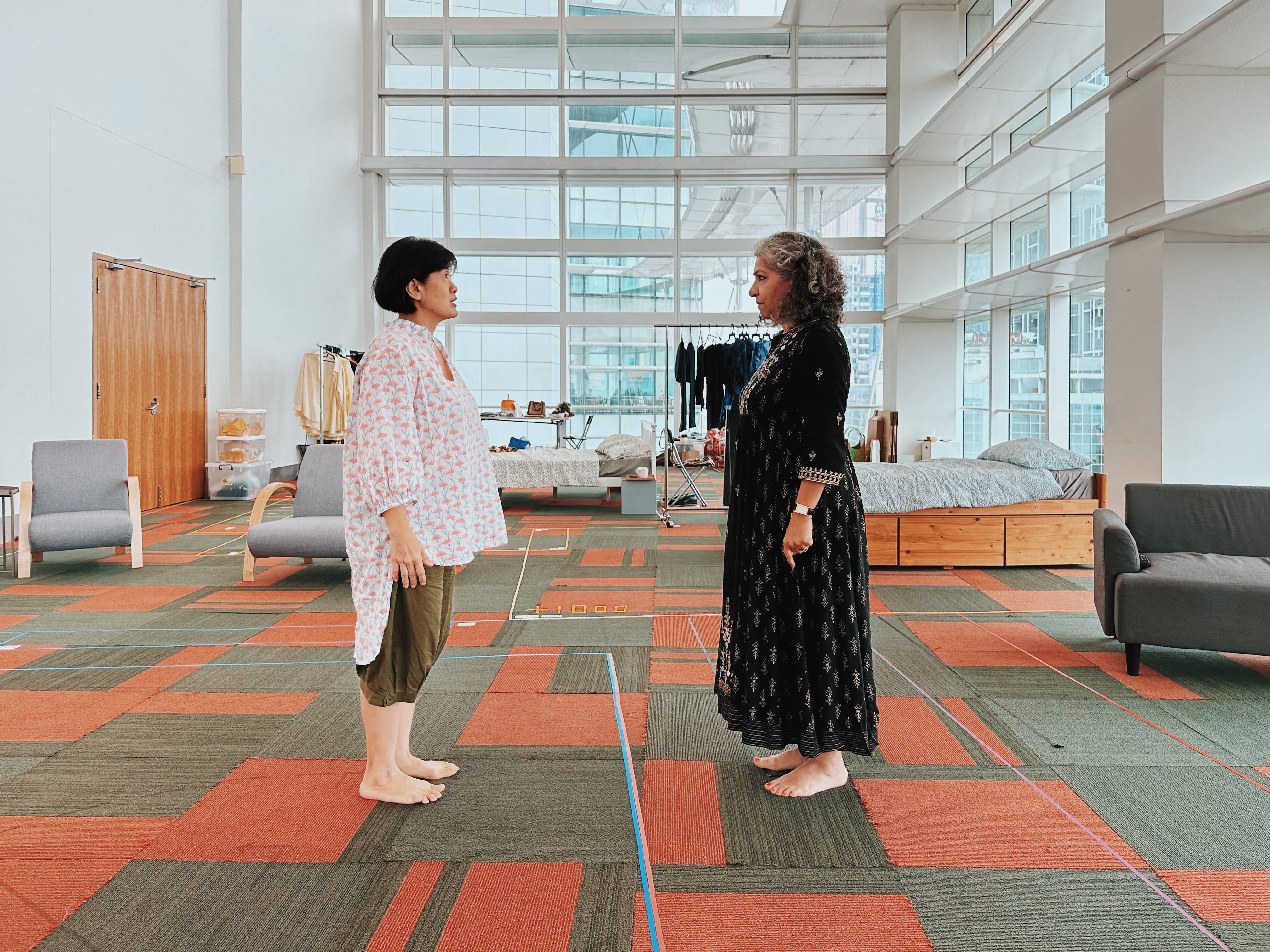 Wide shot of Karen Tan and Daisy Irani facing each other