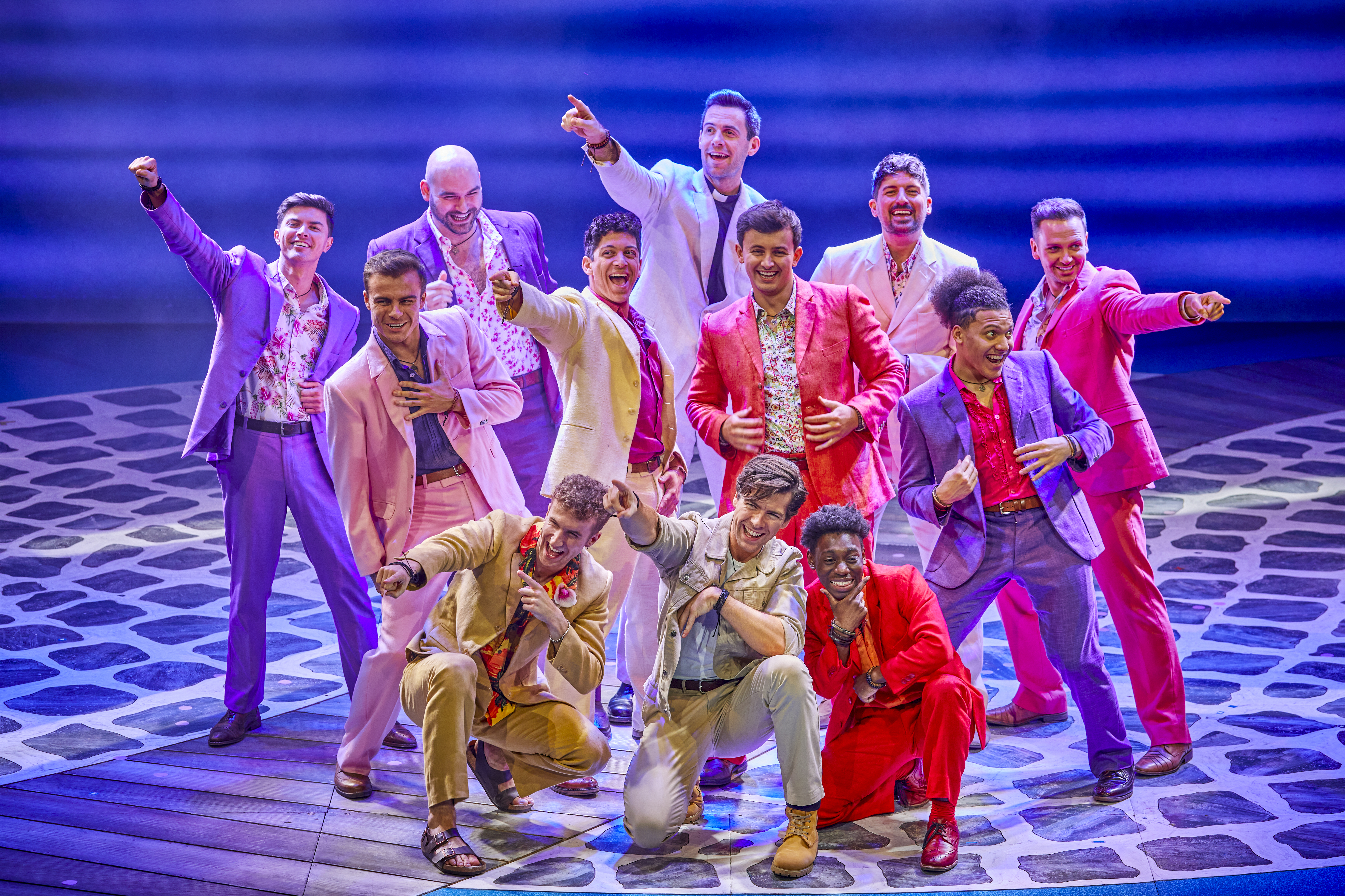Wide shot of Christopher Foley and the ensemble cast onstage in MAMMA MIA!