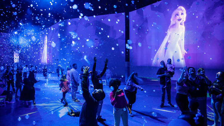 Wide shot of people interacting with the Immersive Disney Animation at Sands Theatre