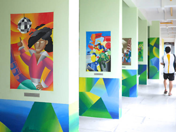 Wide shot of artwork painted on the wall columns of a HDB block