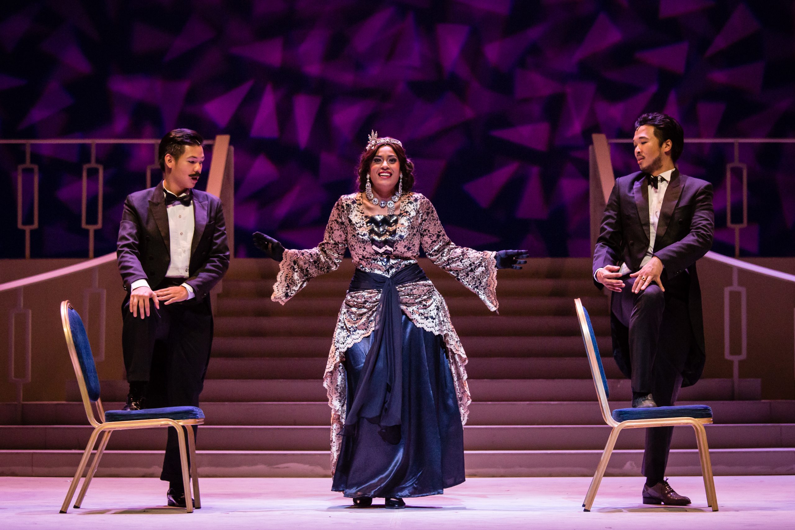 Wide shot of opera performers singing on stage