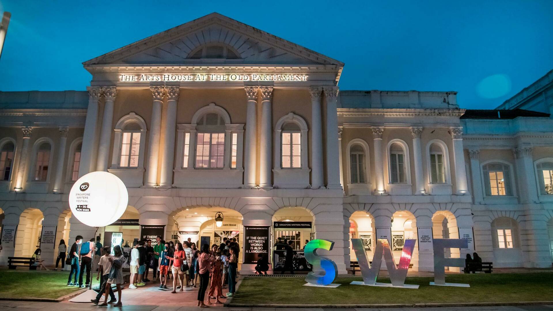 Wide shot of people gathered in front of The Arts House 