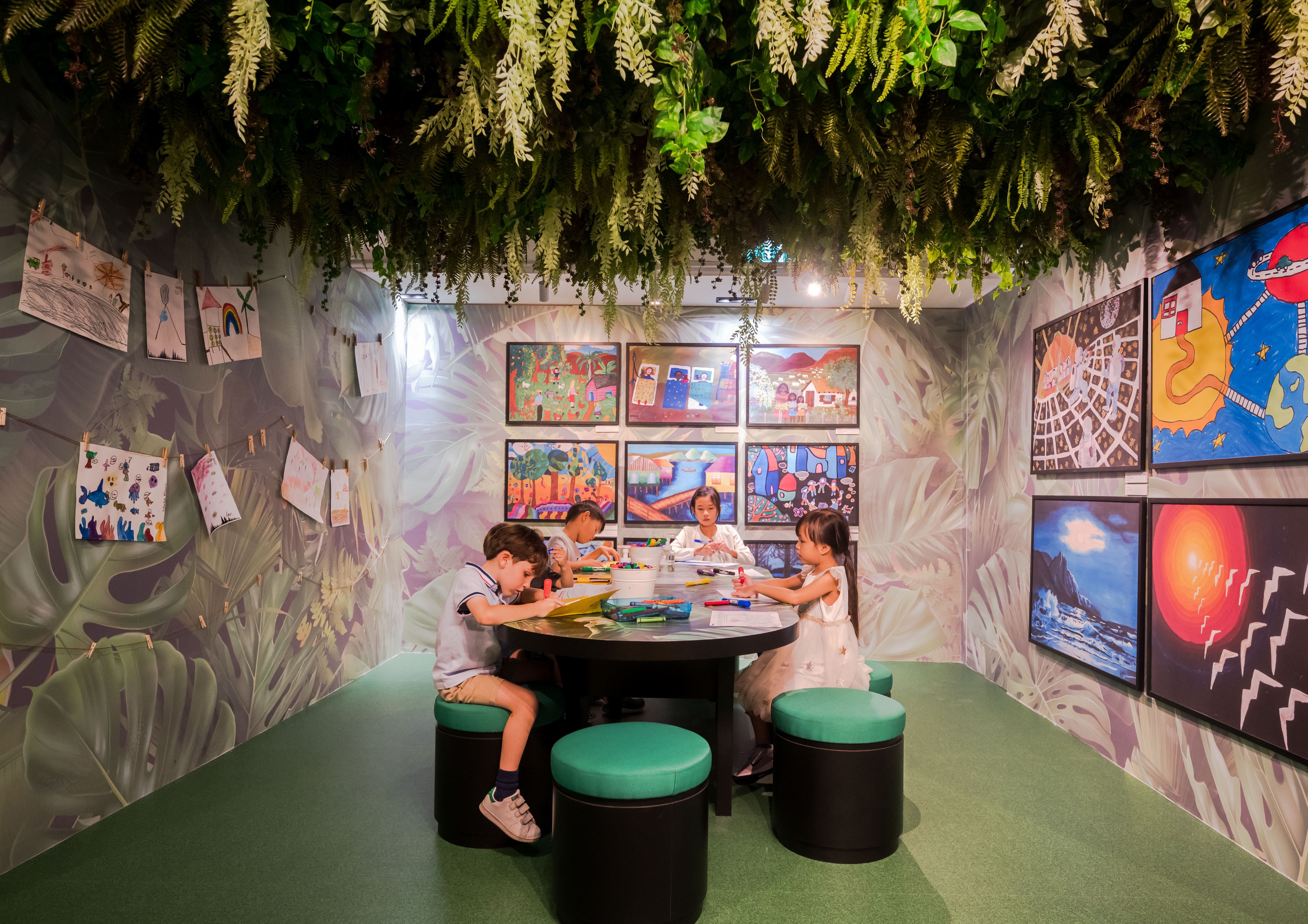 Wide shot of children drawing in The Magic Forest installation