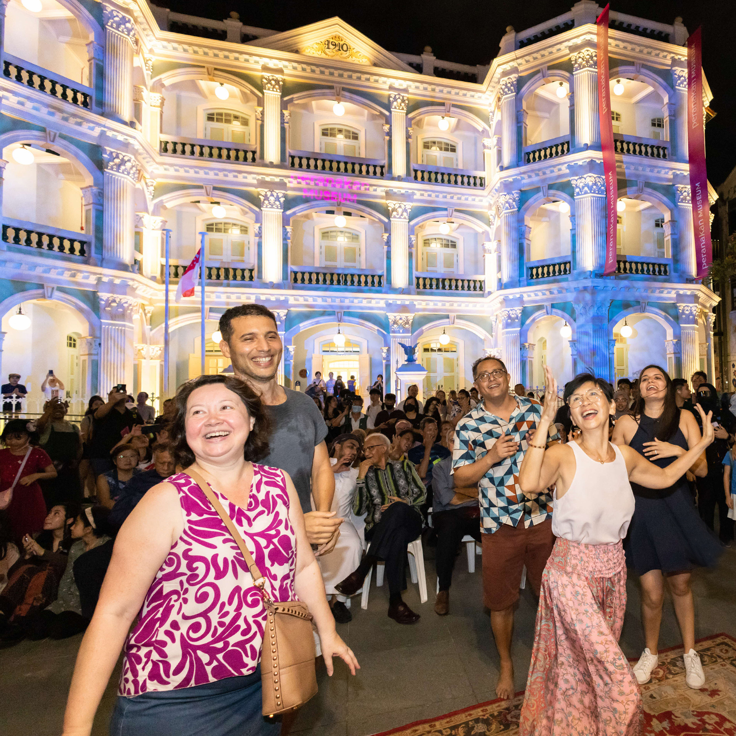 Wide shot of people enjoying the festivities in front of the Peranakan Museum