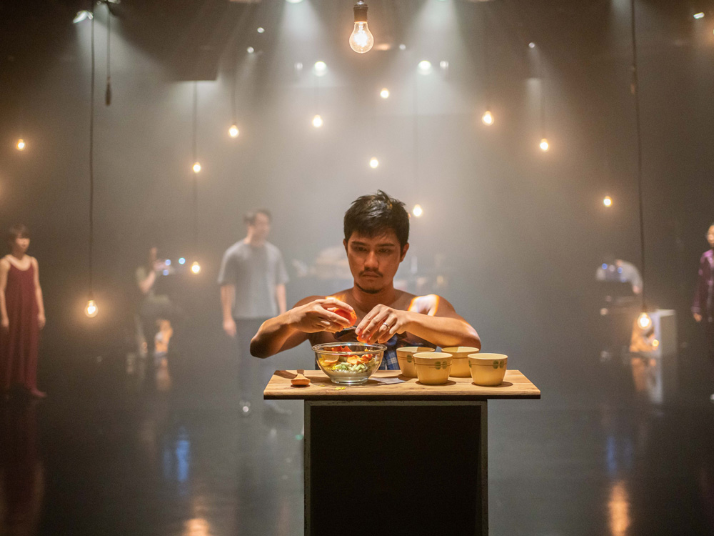 Mid shot of a male performer in mid-performance 