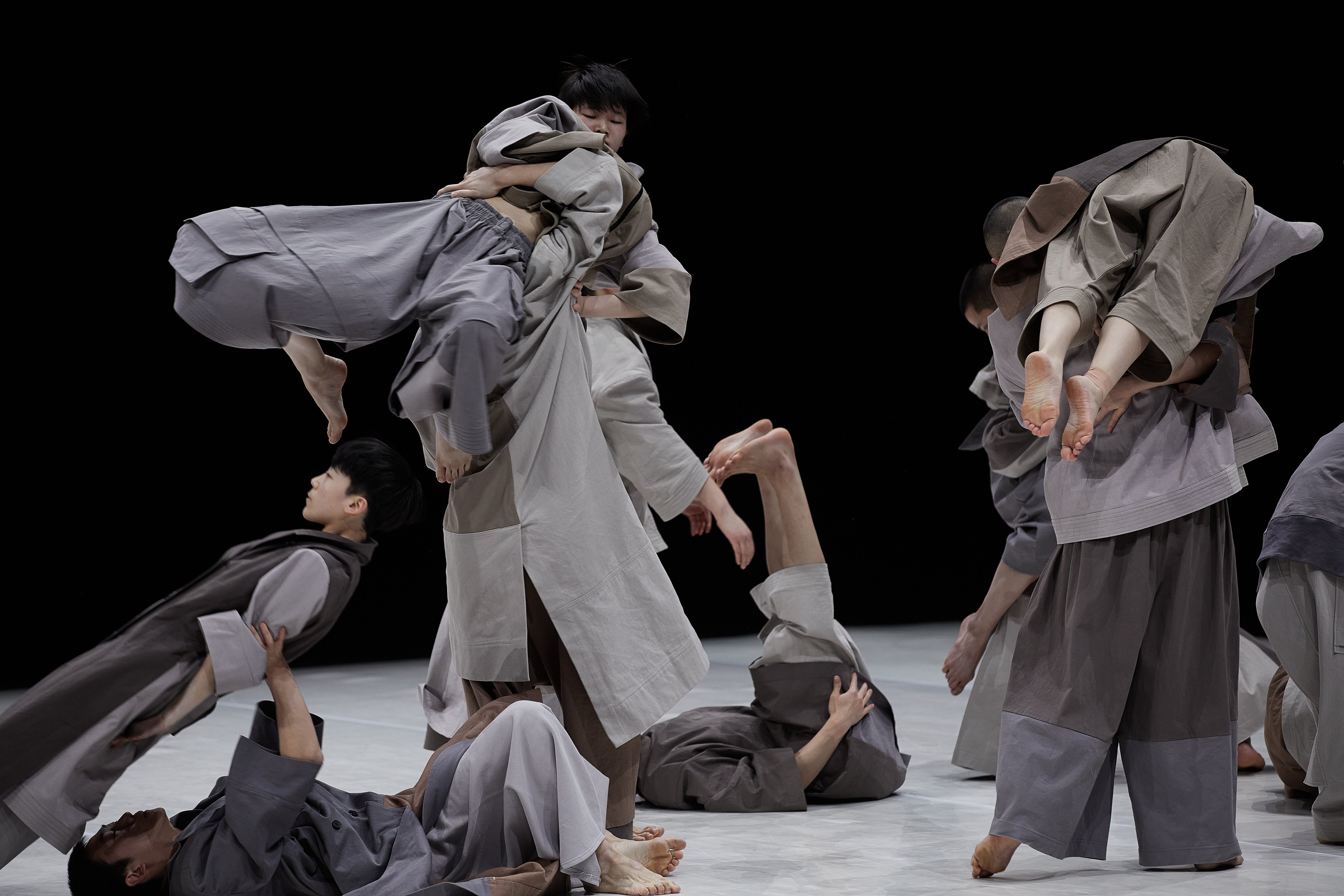 Wide shot of dancers dancing in unison