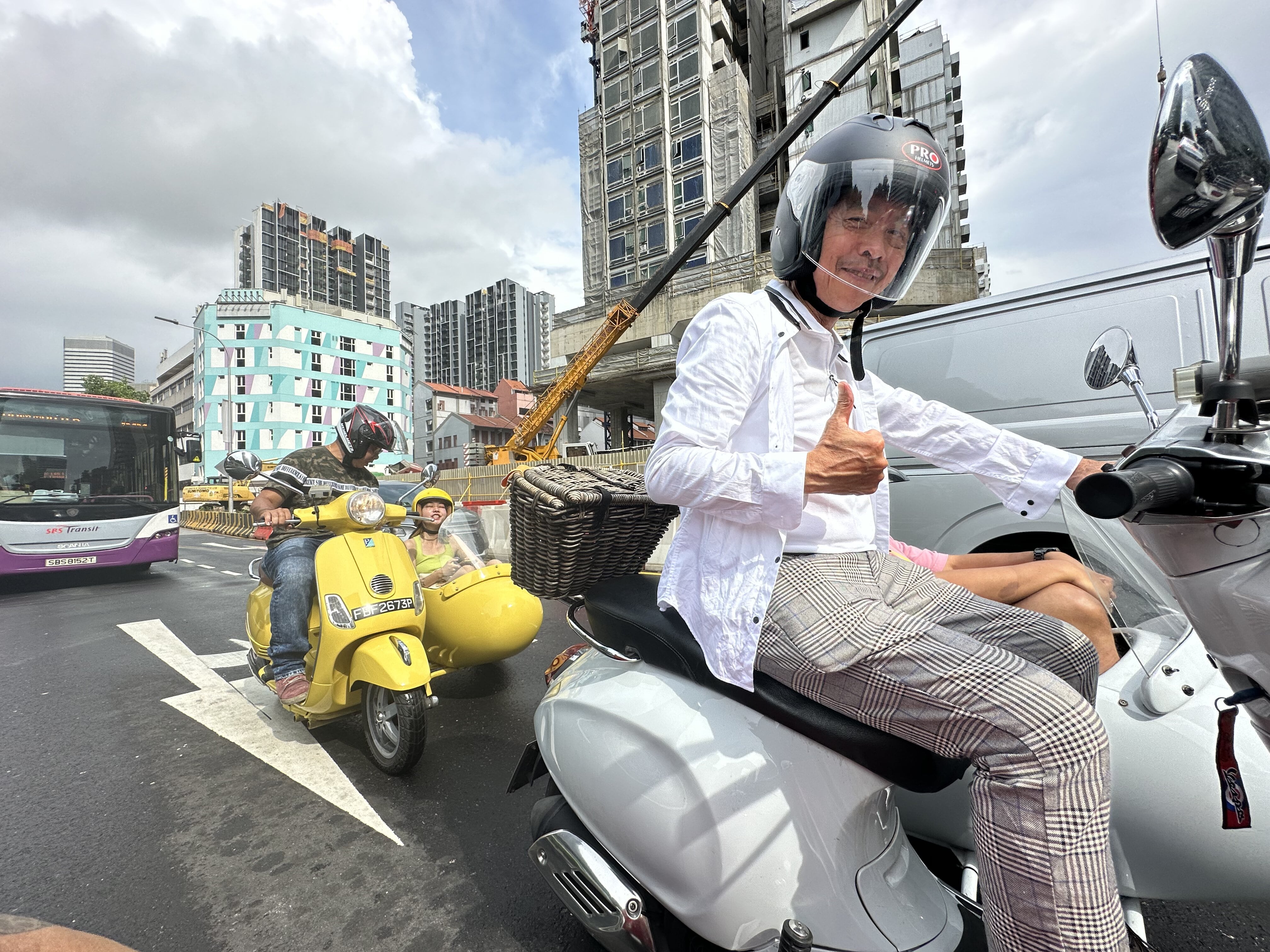 Mid shot of a Vespa sidecar guide posing for the camera