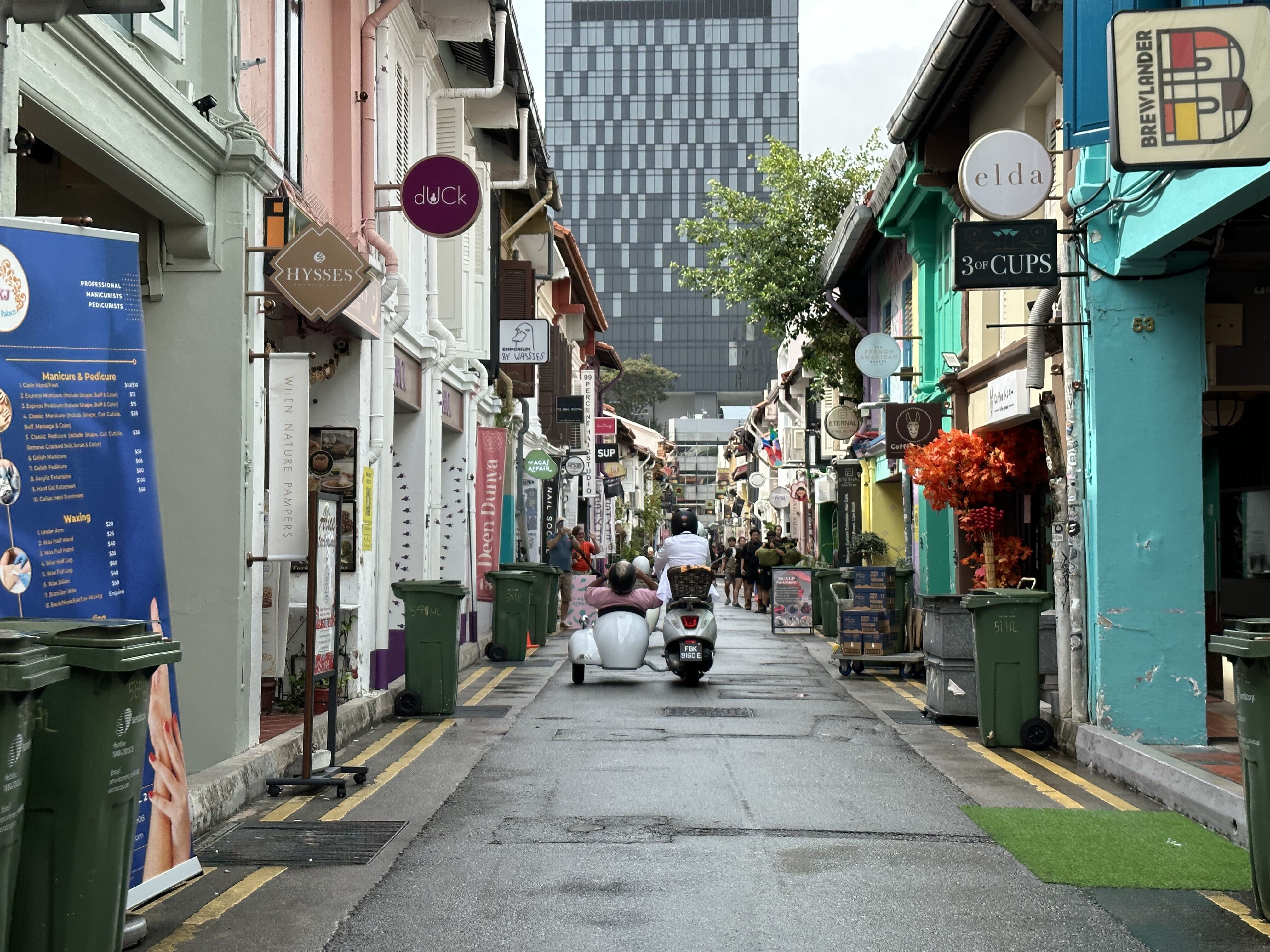Wide shot of a Vespa sidecar on the streets of Haji Lane