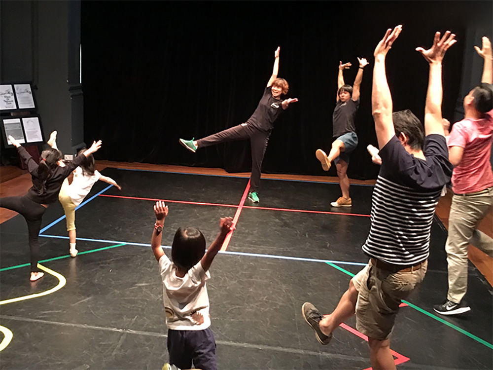 Wide shot of RAW Moves dance inst Insructors leading children in a workshop
