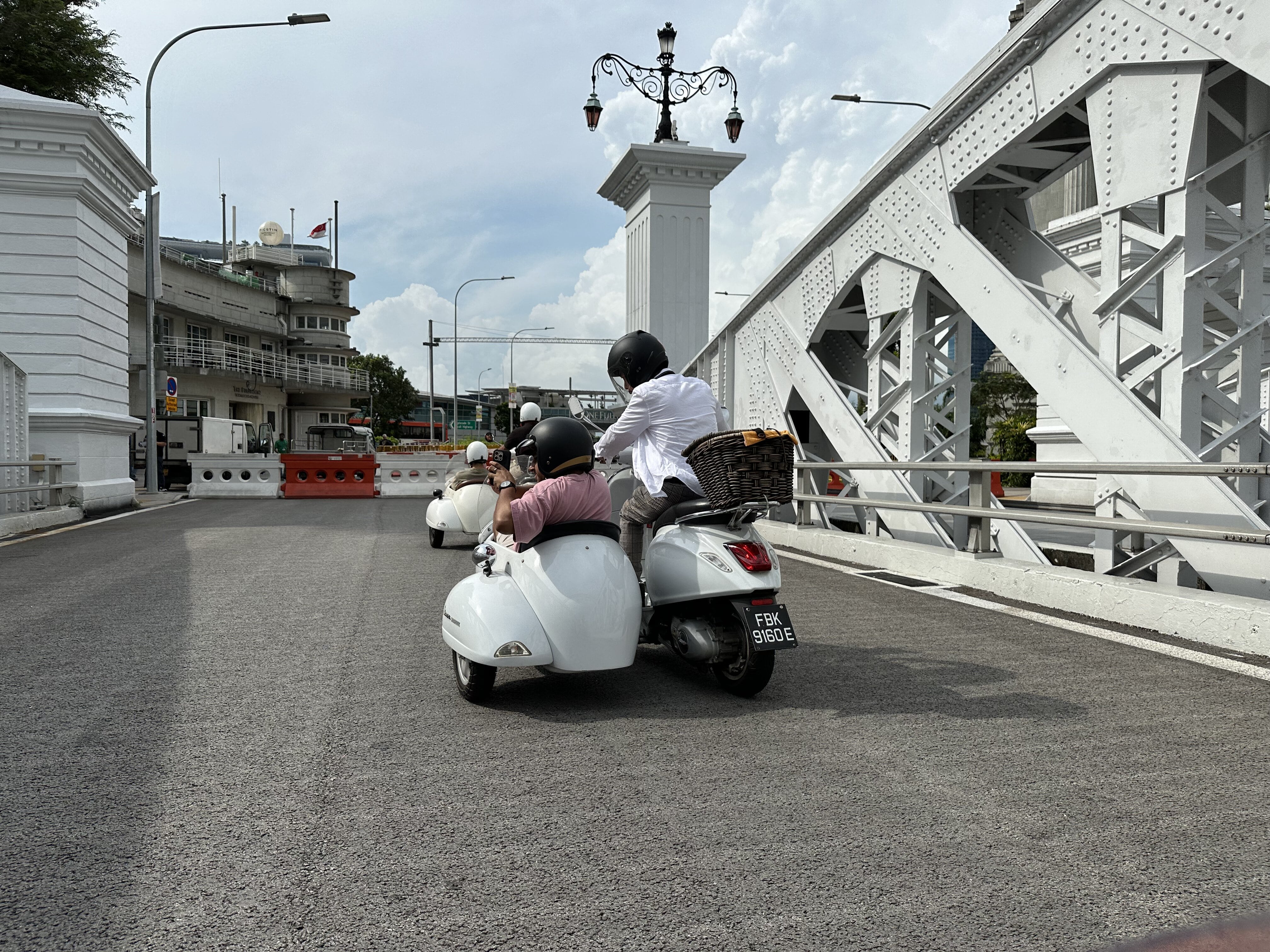Wide shot of a Vespa sidecar in action on the street