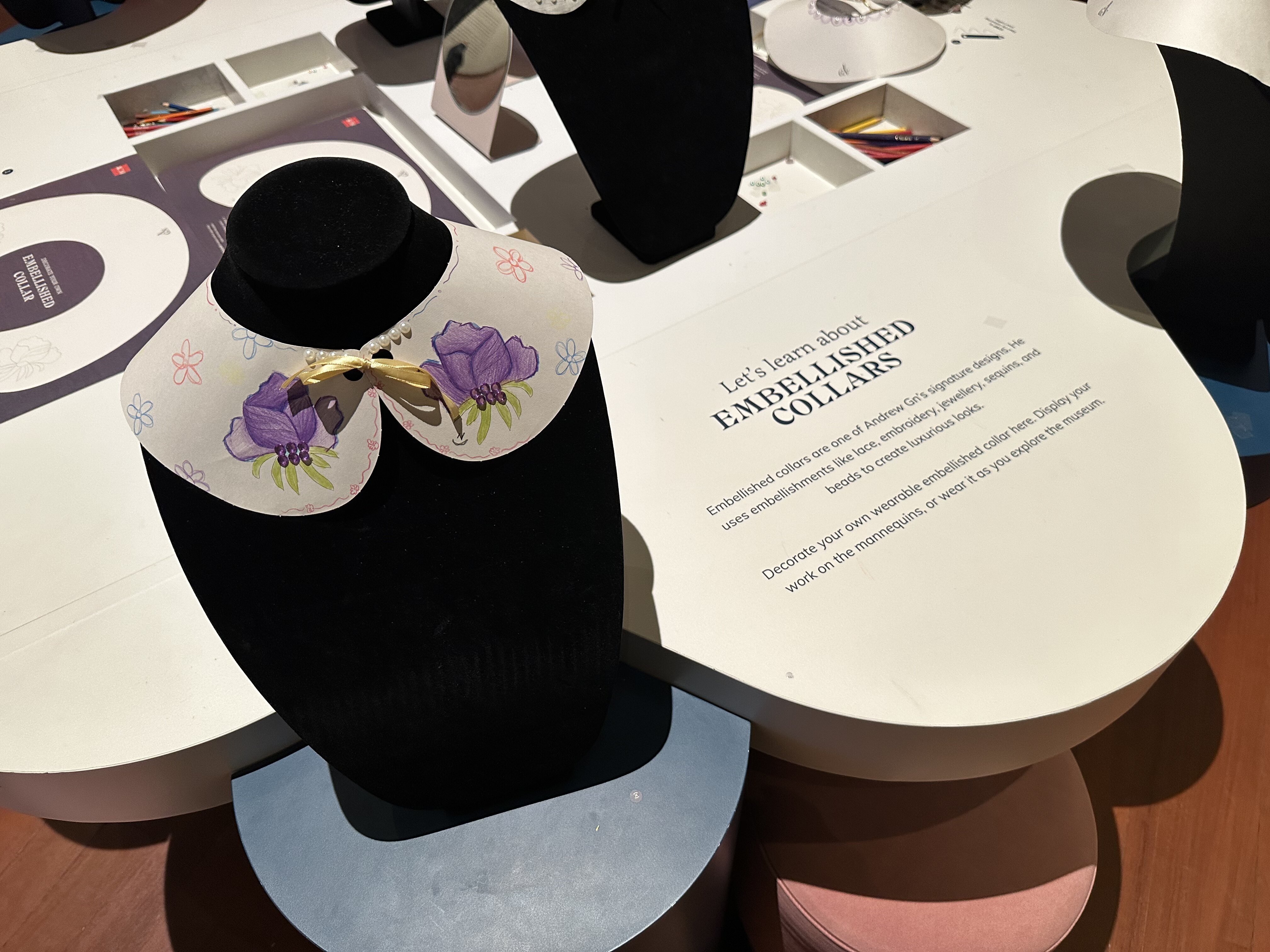 Close-up of a collar design on display
