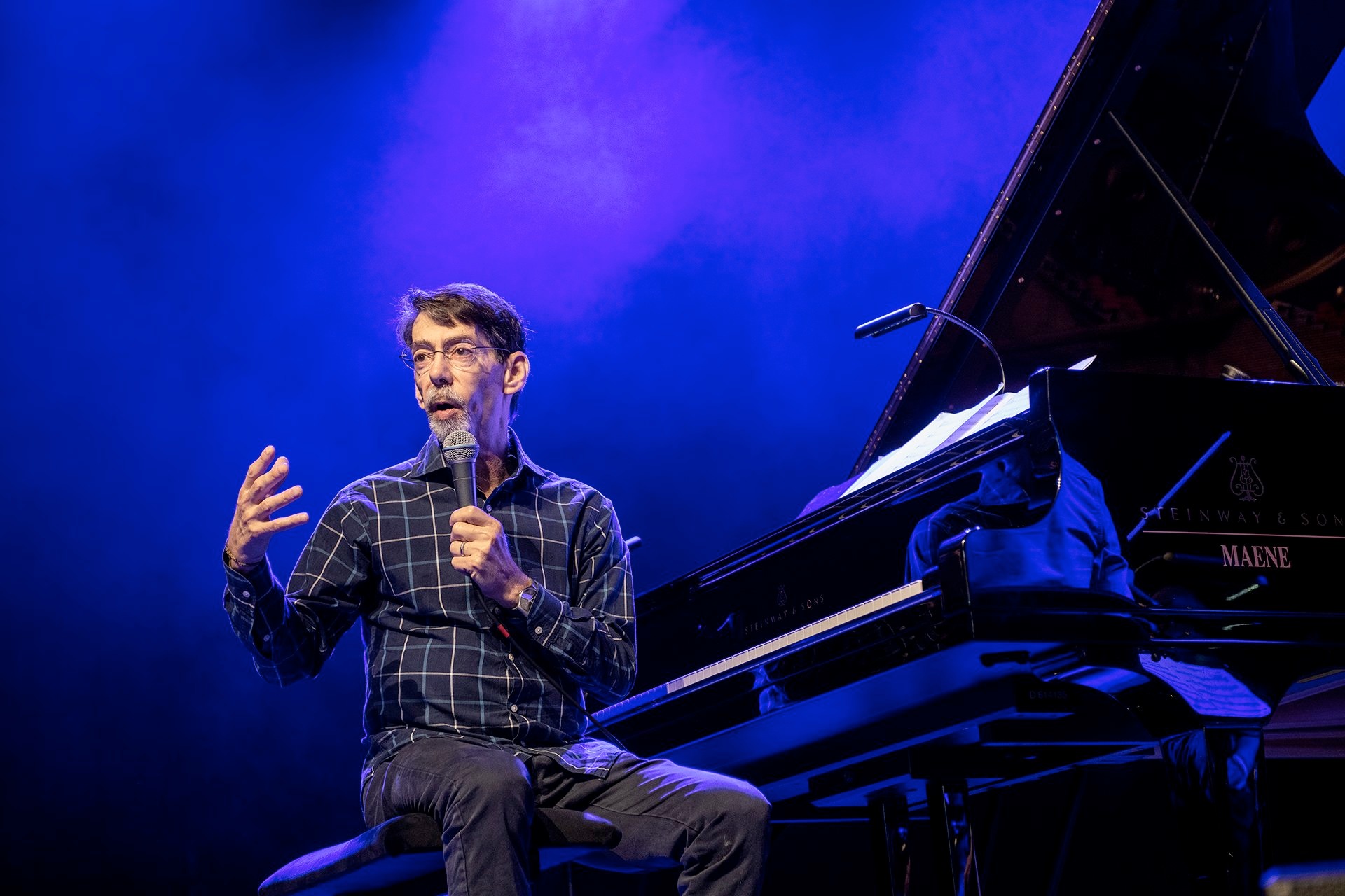 Fred Hersch speaking to his audience onstage 