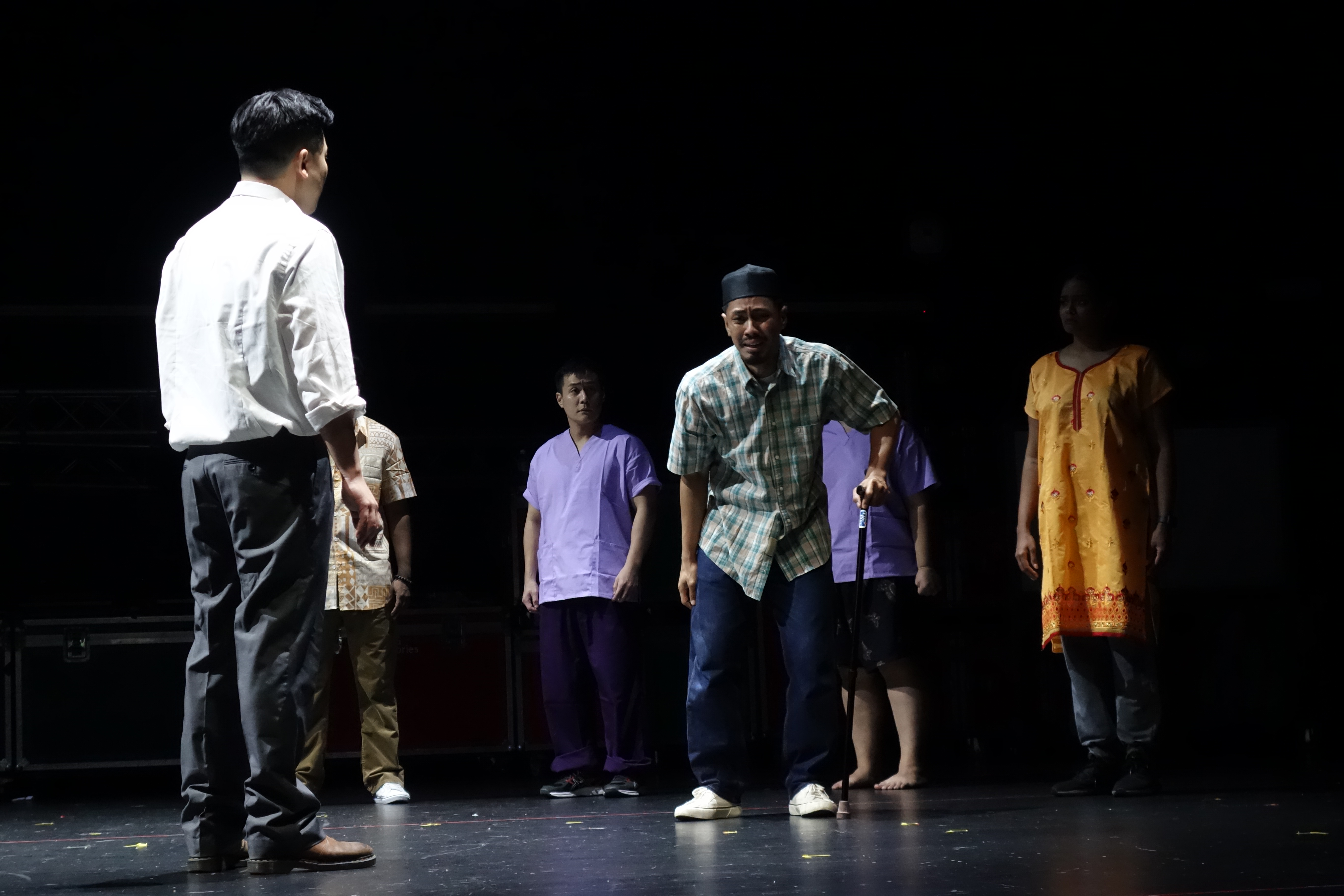 Wide shot of cast members during a emotionally moving scene