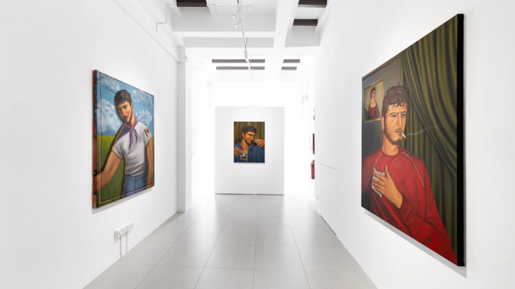Wide shot of walkway featuring paintings from Spaces In-Between by Israfil Ridhwan