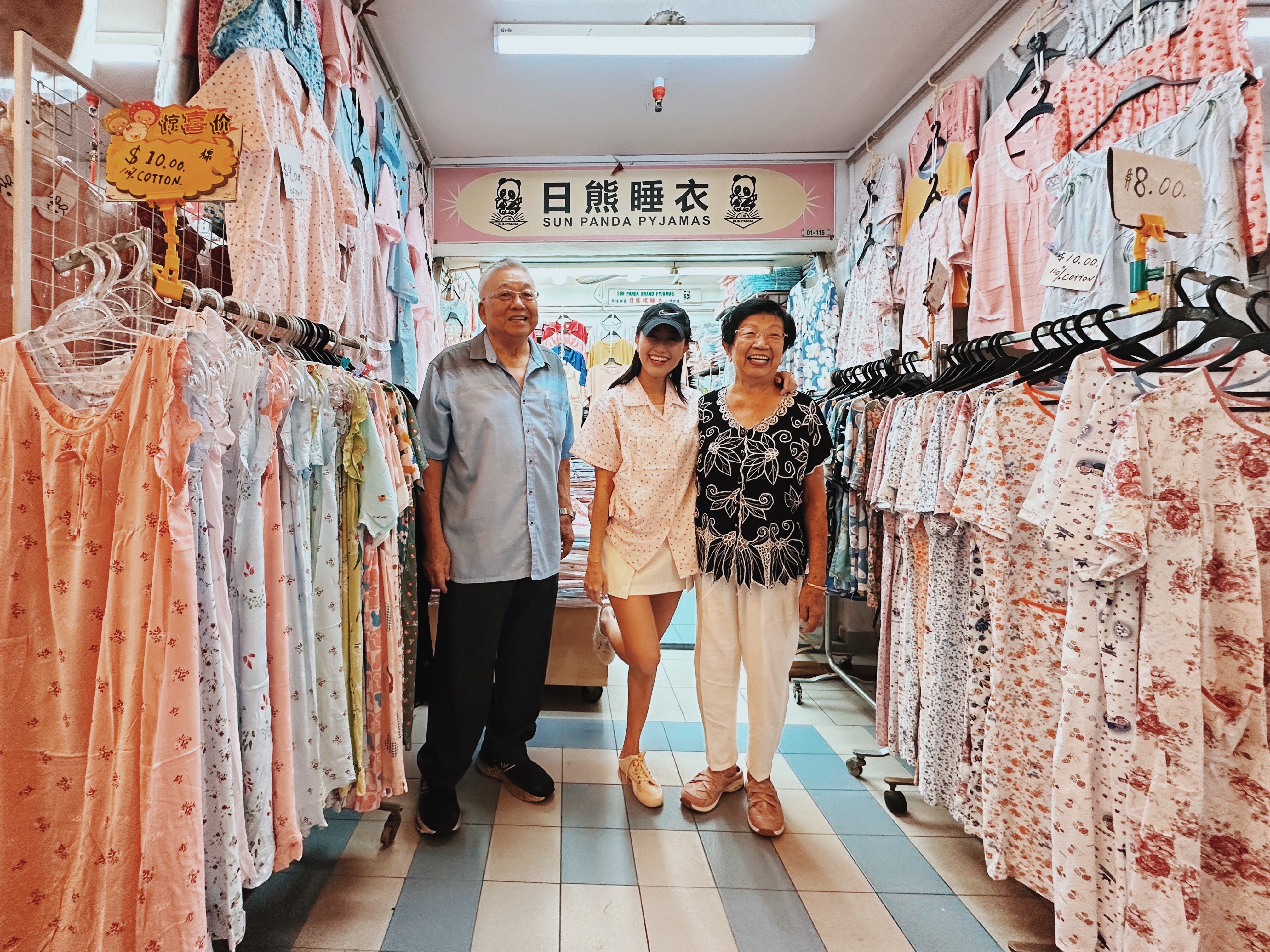Wide shot of attendee with elderly couple, flanked by pyjamas