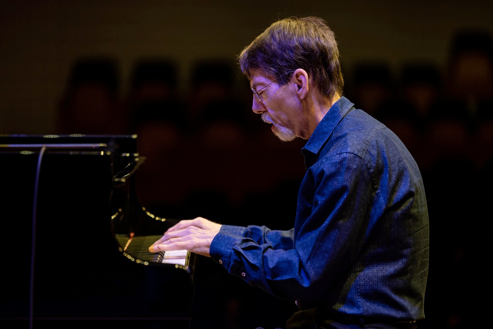 Mid shot of Fred Hersch playing the piano during a performance