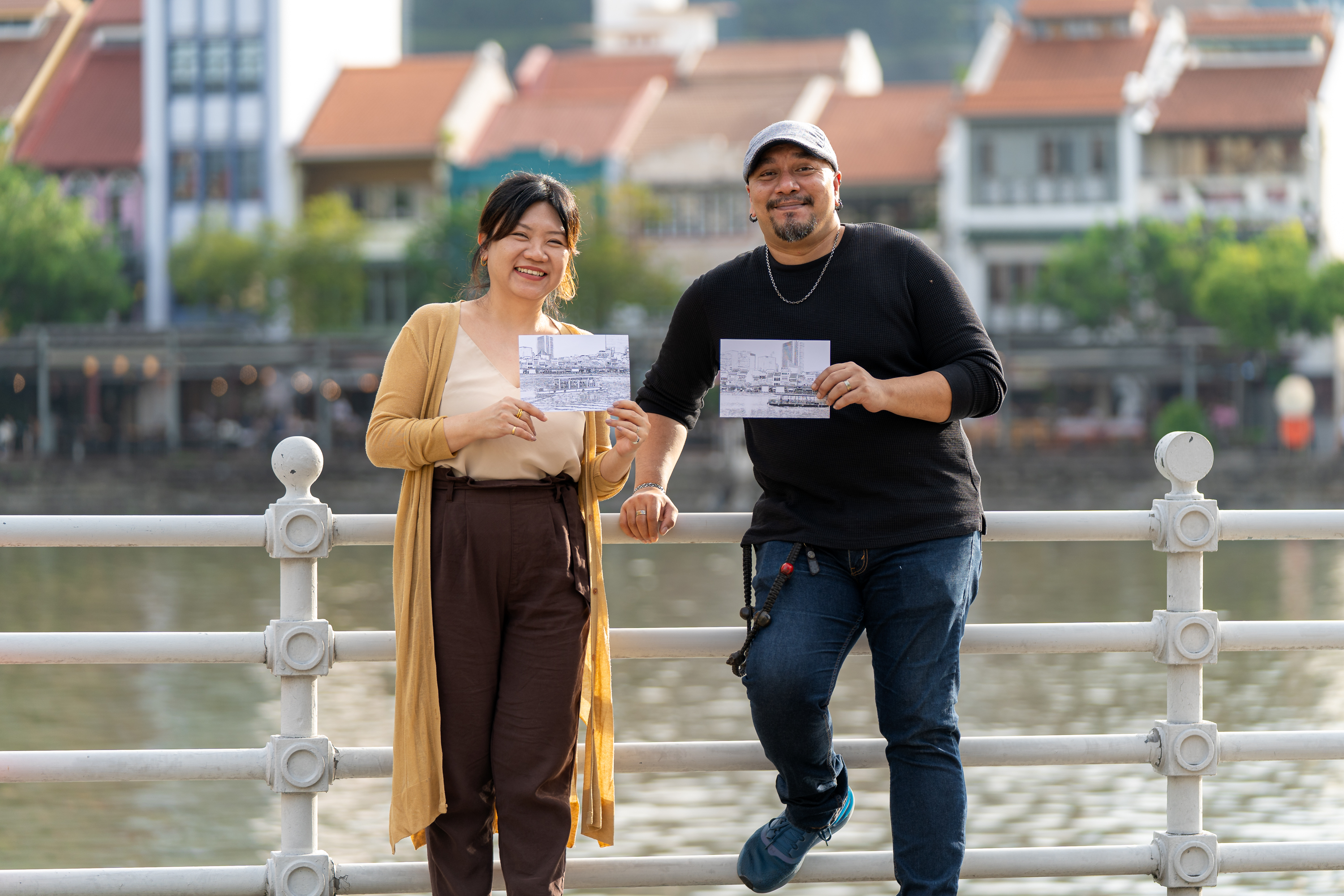 Wide shot of Victor Emmanuel and Stellah Lim by the Singapore River