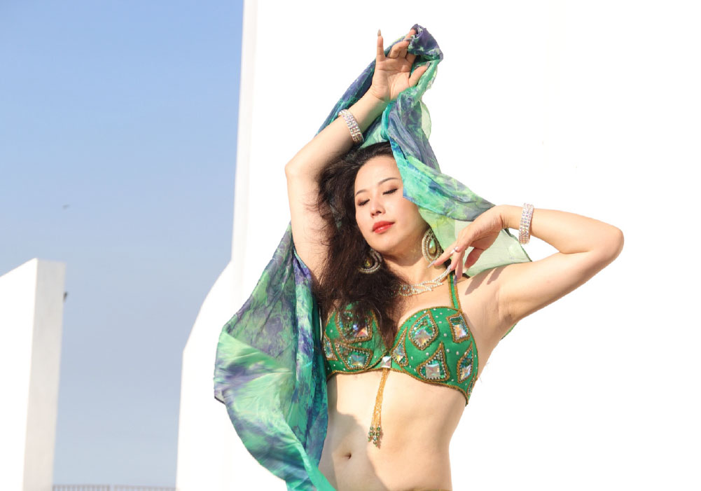 Mid shot of a belly dancer in full costume ensemble