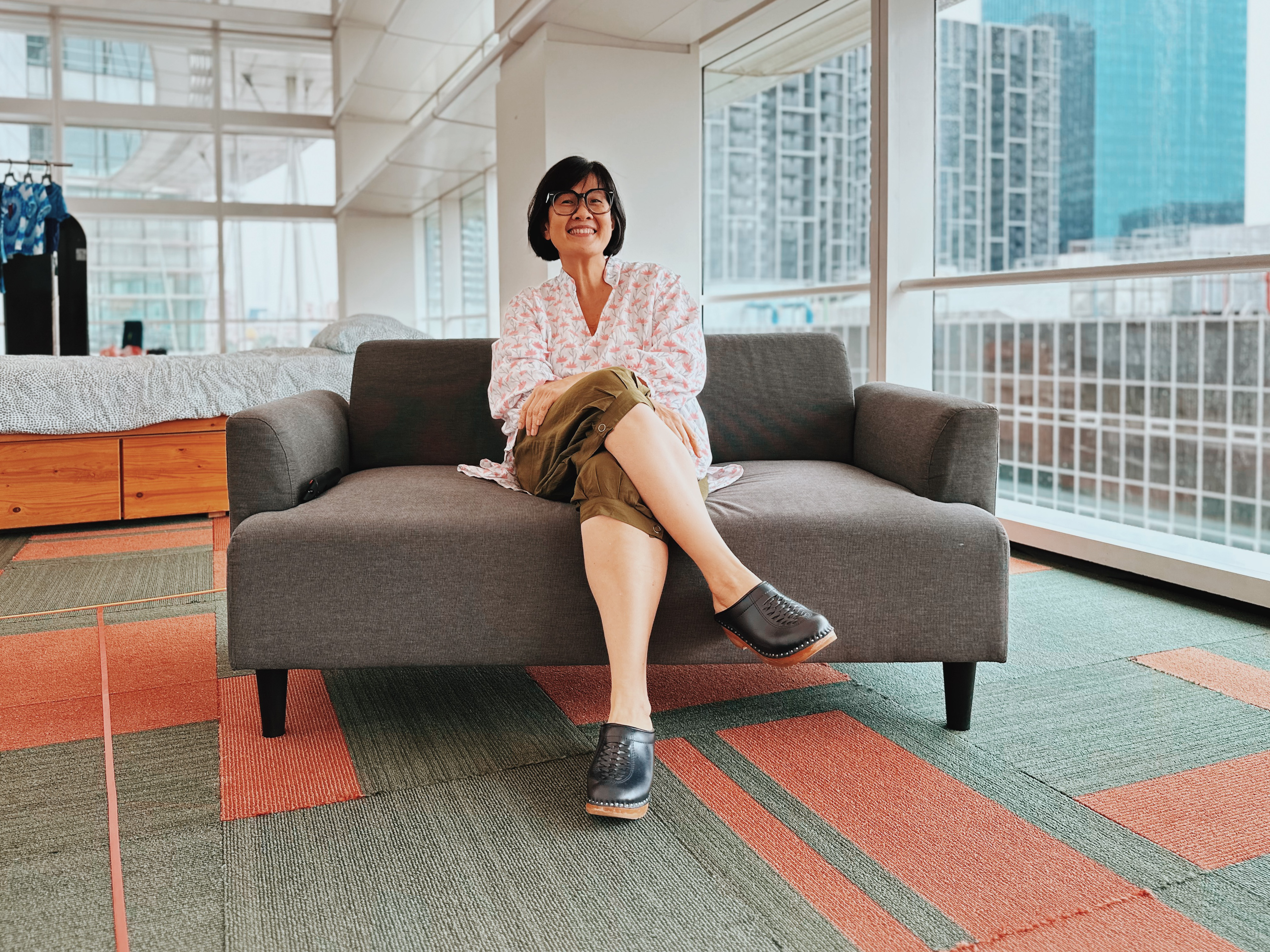 Profile shot of Karen Tan sitting on a chair