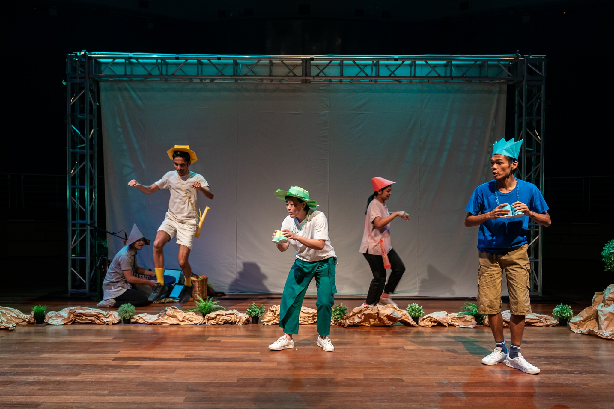Wide shot of five cast members performing onstage 