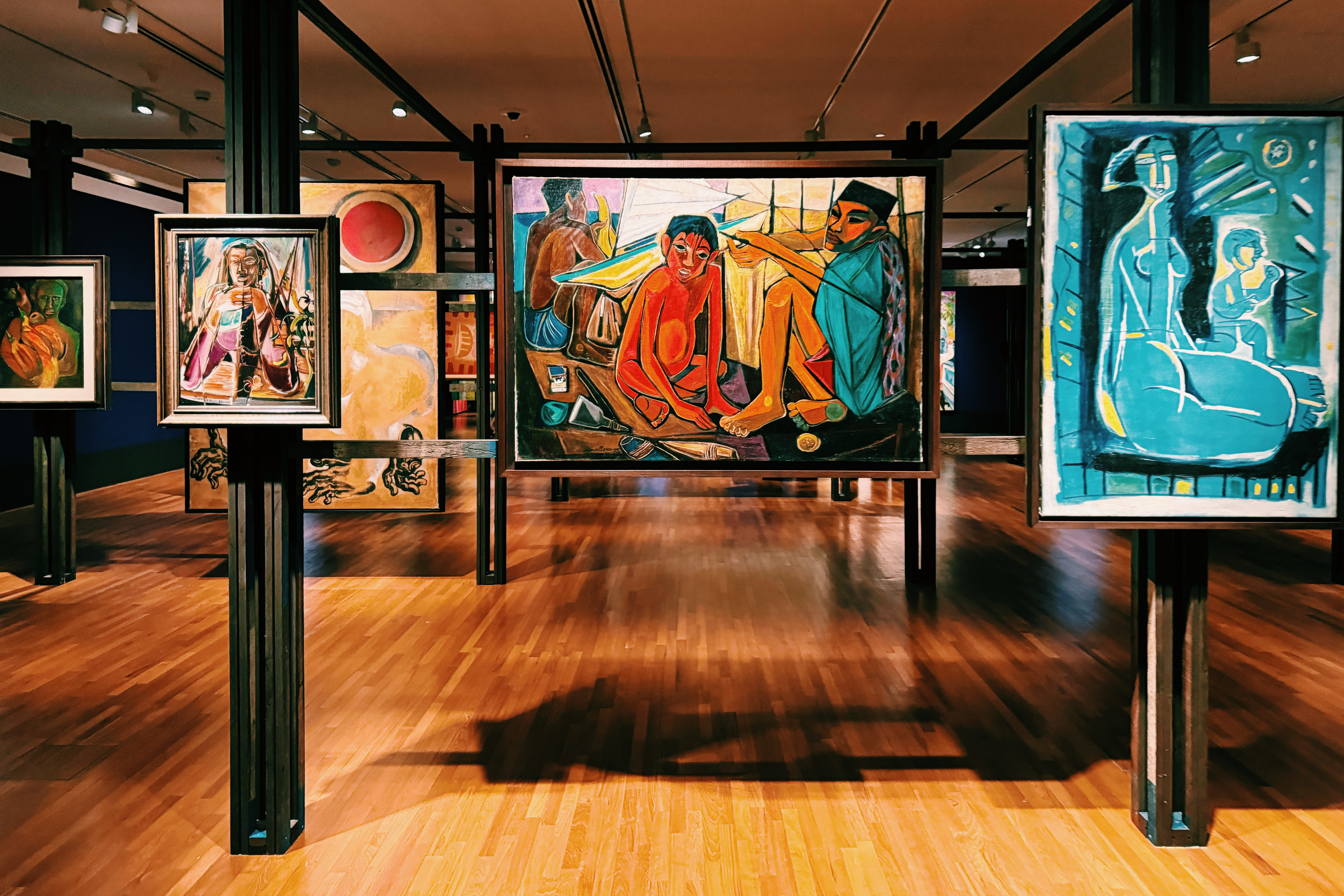 Wide shot of colourful paintings of people