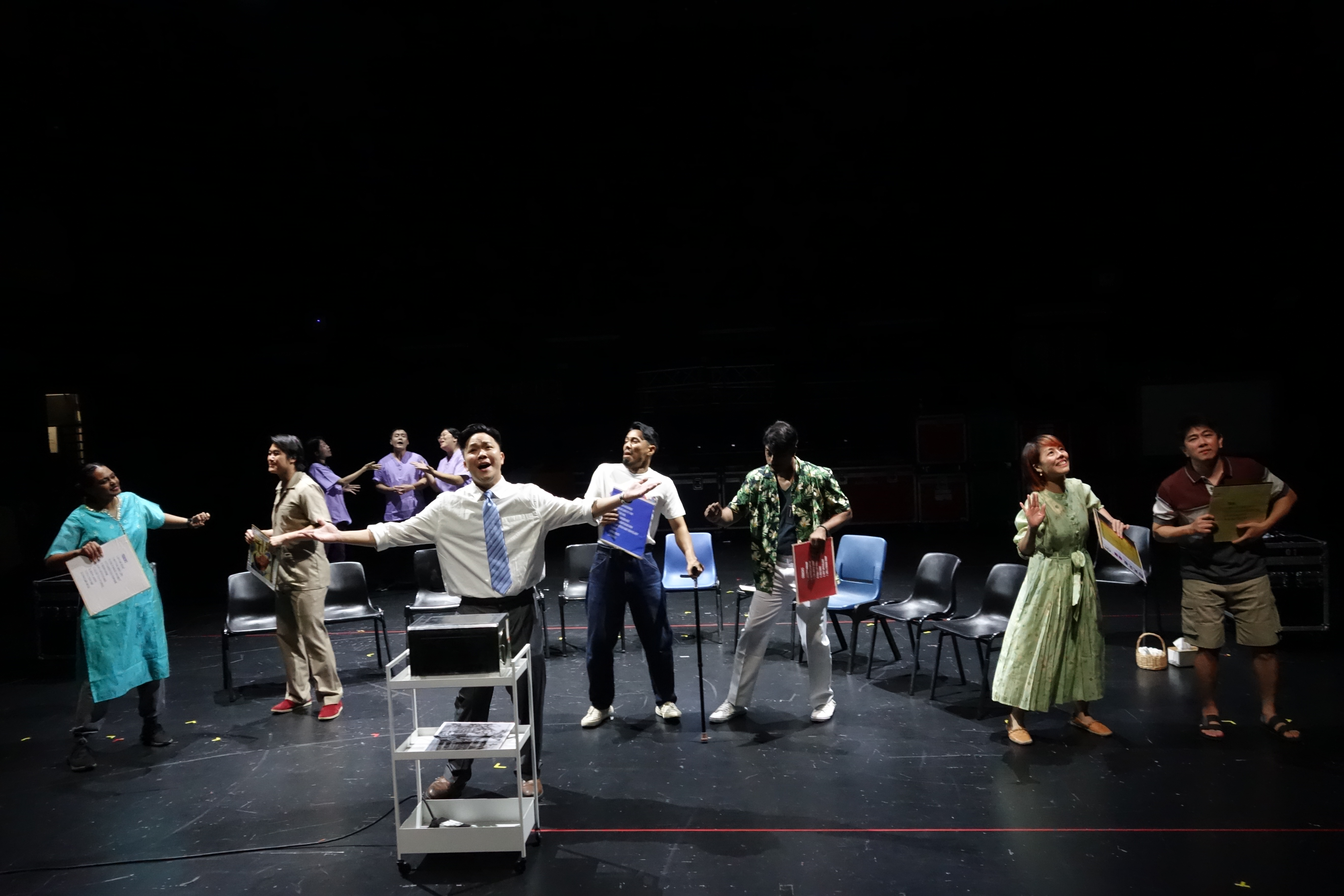 Wide shot of the cast members singing “Time was a Jukebox”