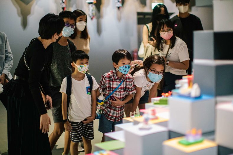 Wide shot of families with children on a curator tour