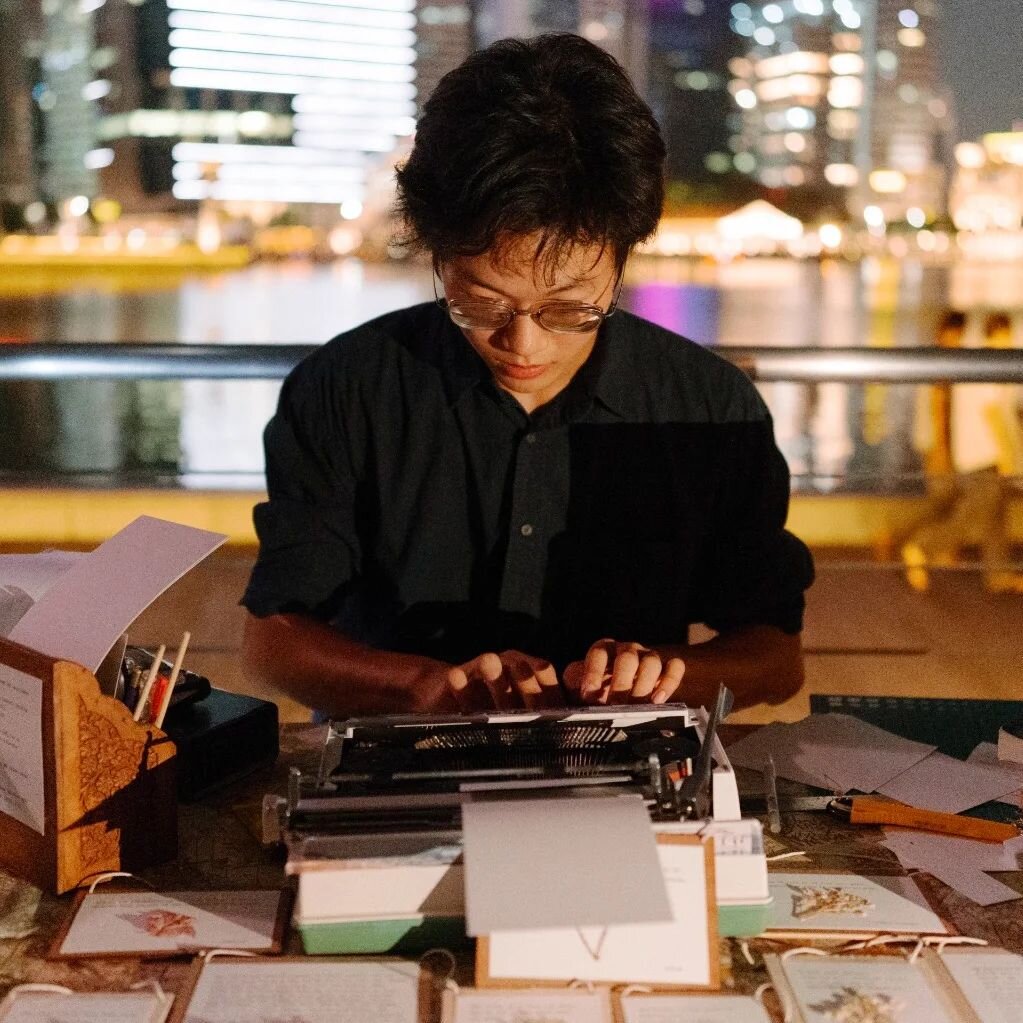 Close up of Ang Ben Wei typing on a typewriter 
